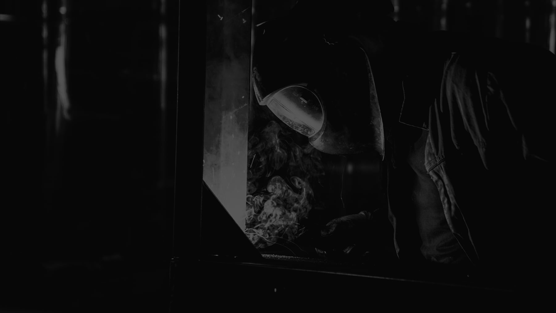 Worker welding in an industrial environment